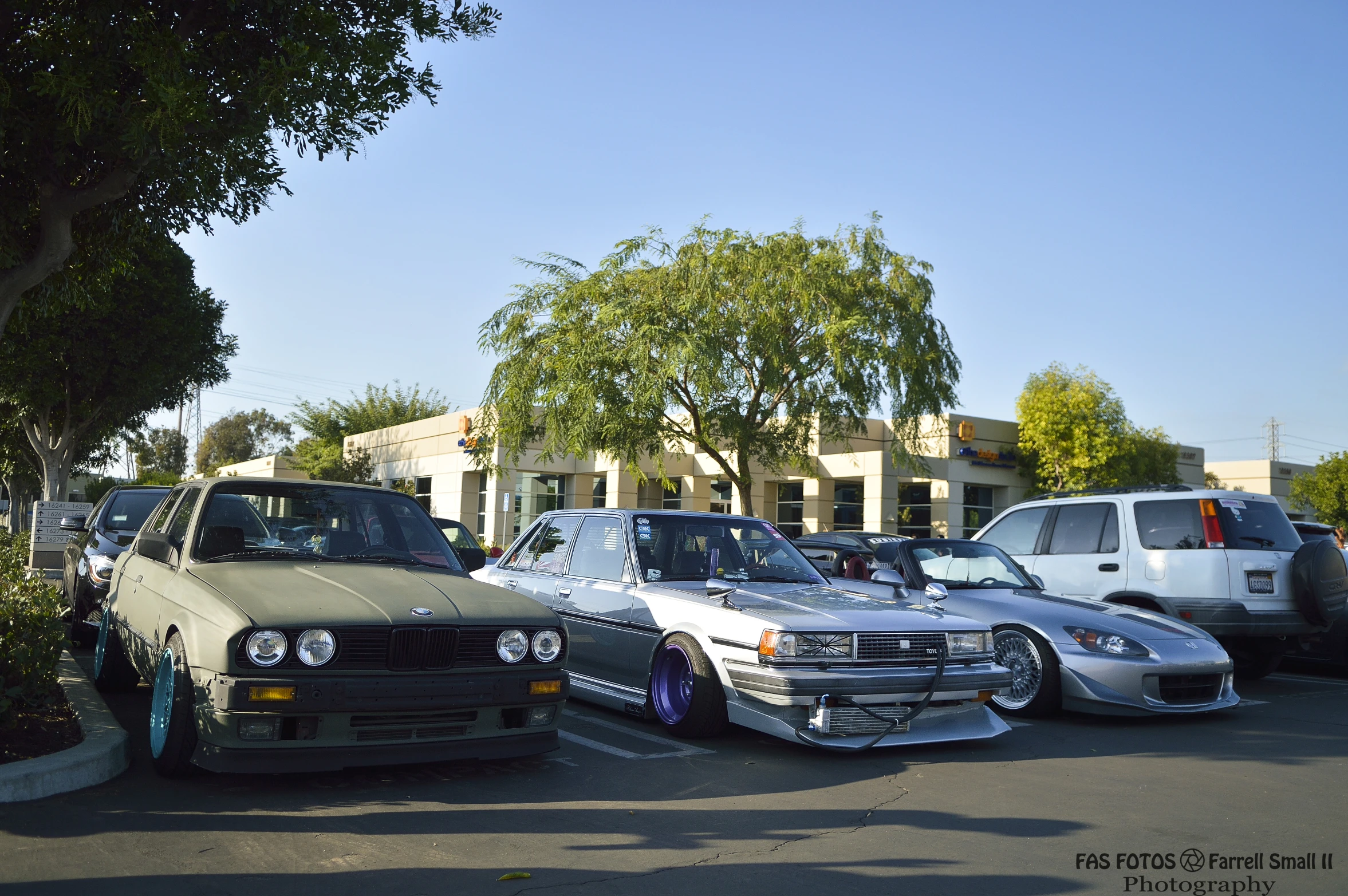 a row of parked cars in a parking lot