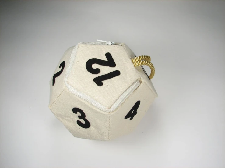 a dice with numbers written on it sits