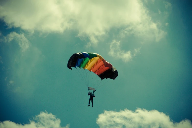 a person standing under a large kite in the sky