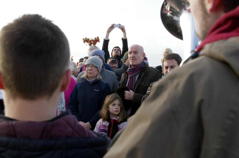 a large crowd is standing together and waiting for a performance