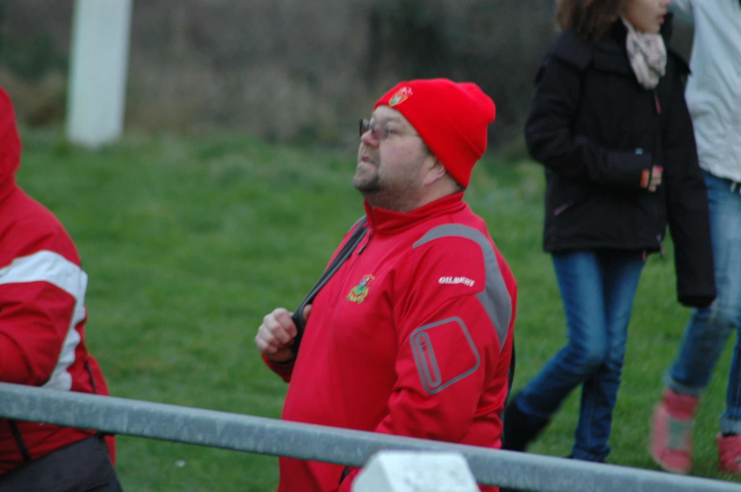 three people in red jackets are watching soing