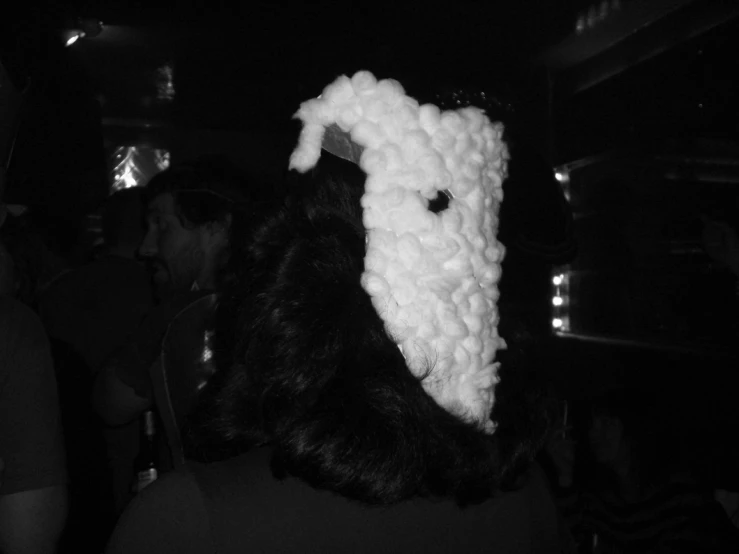 a sheep head is wearing a knit sweater and it's scarf