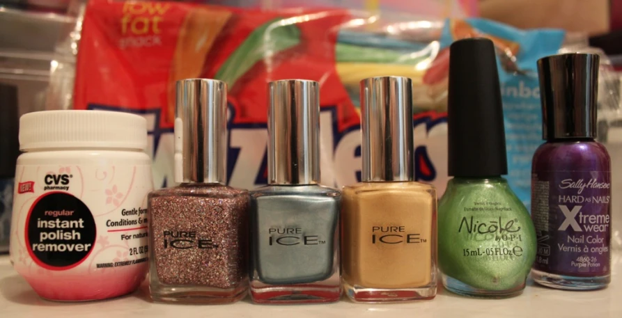 a row of nail polishes sitting on a table