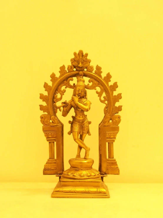 small statue of hindu god holding the cross on one hand and facing upwards