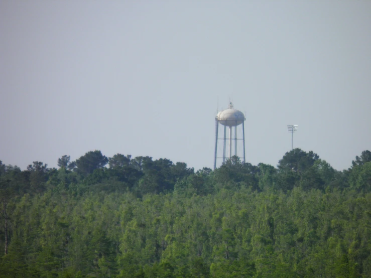 there are several water towers on the top of a hill