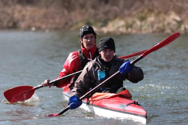 a couple of people in a red kayak in the water