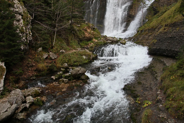 the water is rushing over rocks and boulders