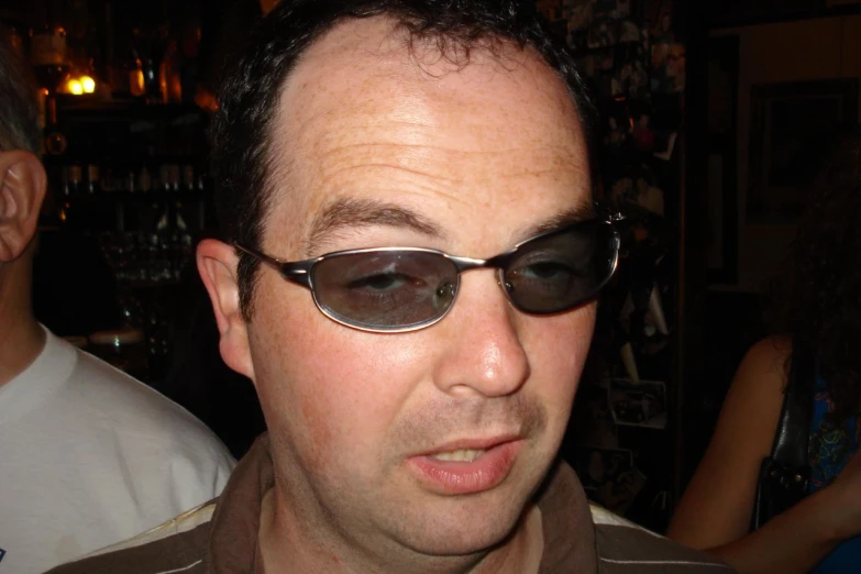 a close up of a man wearing a pair of sunglasses