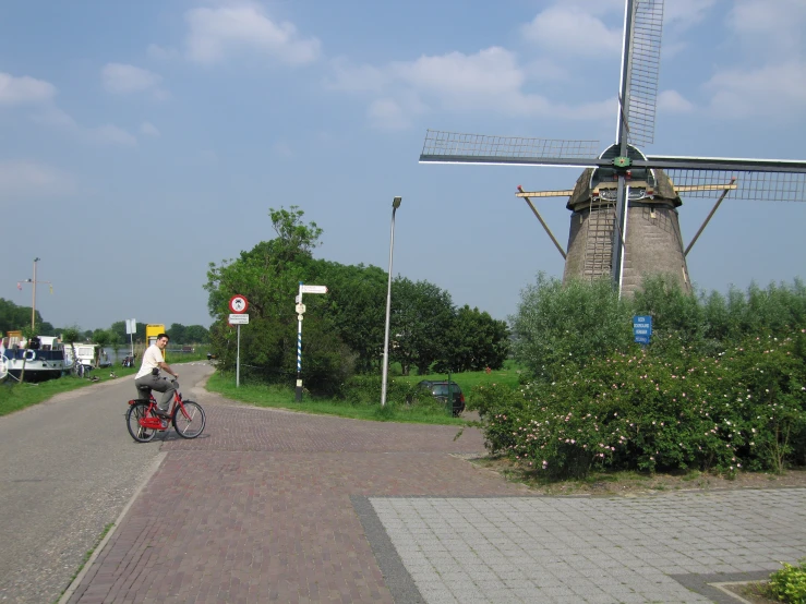 a person that is riding a bike down a brick road