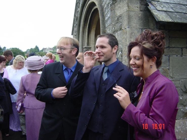 a group of men and women outside of a building