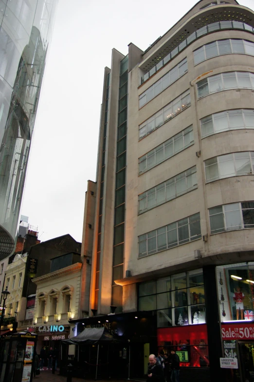 two large buildings sitting on a street next to tall buildings