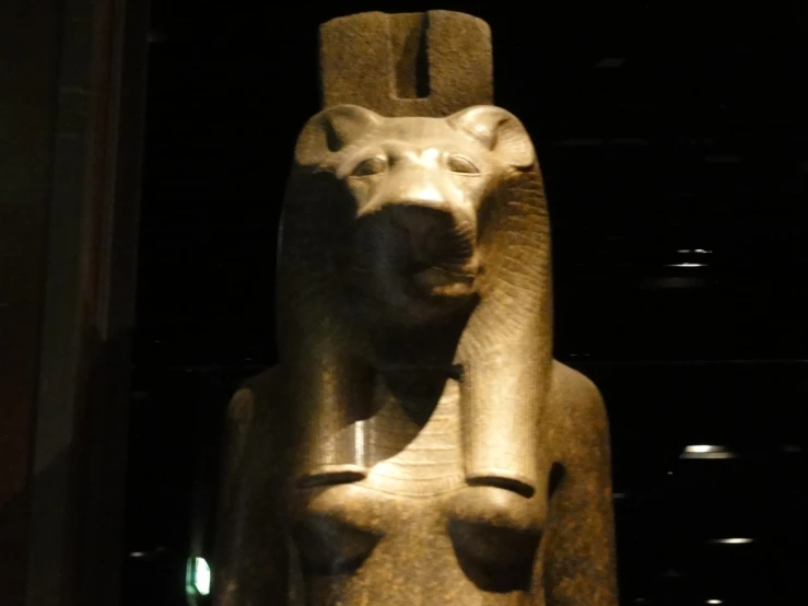 a large stone sculpture is shown against a dark background