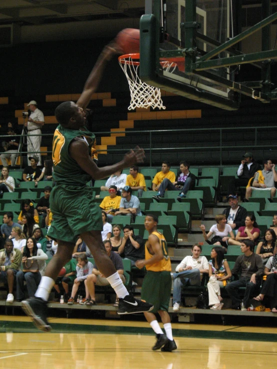 there is a man that is jumping in the air with a basketball