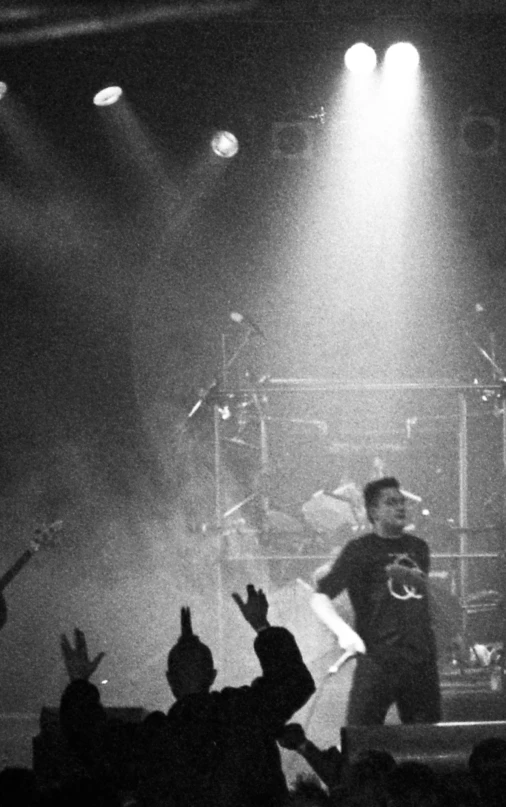 two men standing on a stage and waving