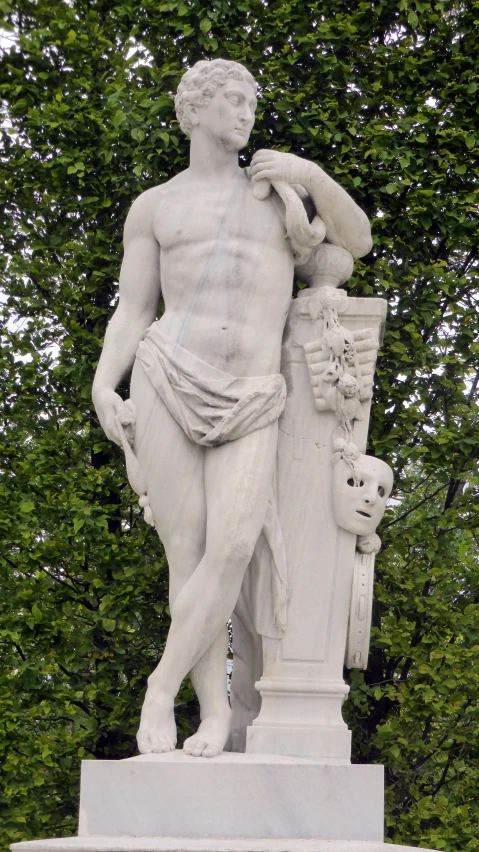 statue in front of trees of various shapes and sizes