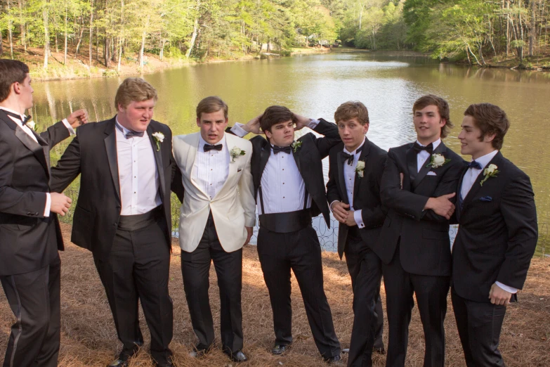 a group of guys dressed up and posing for a picture