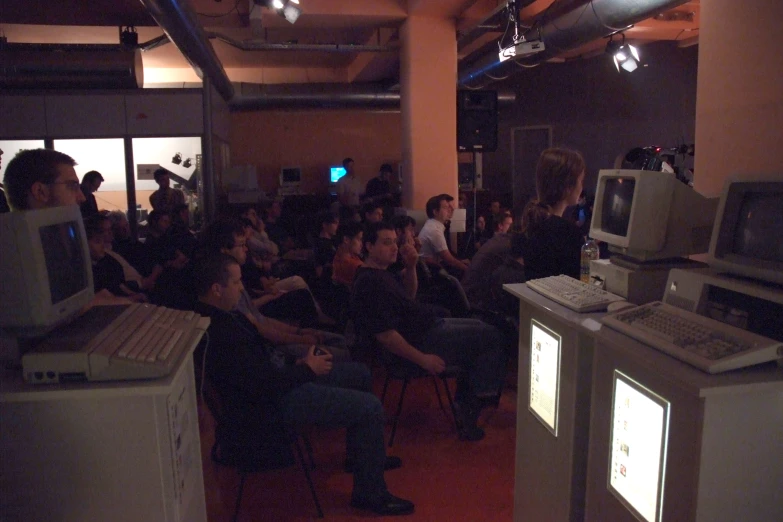 several people sitting around watching a presentation