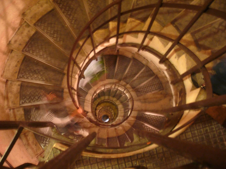 a spiral stair railing and metal rods on a building