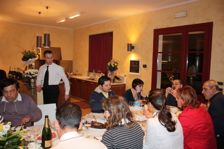 a group of people are sitting at tables in a restaurant