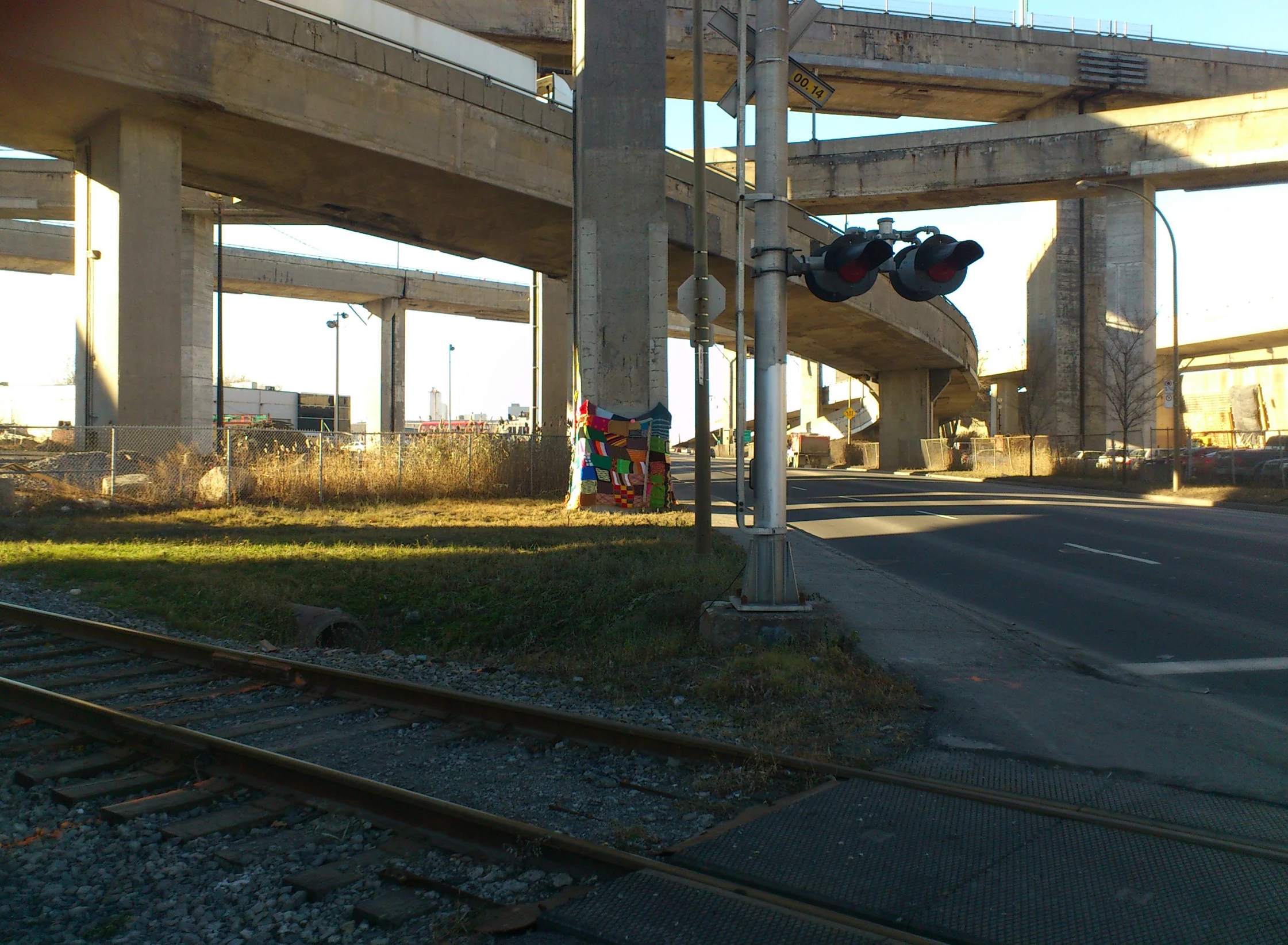 two stop lights sit on one side of a railroad tracks