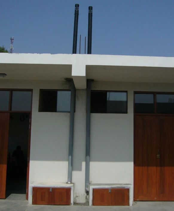 two garage doors next to each other with skis on top