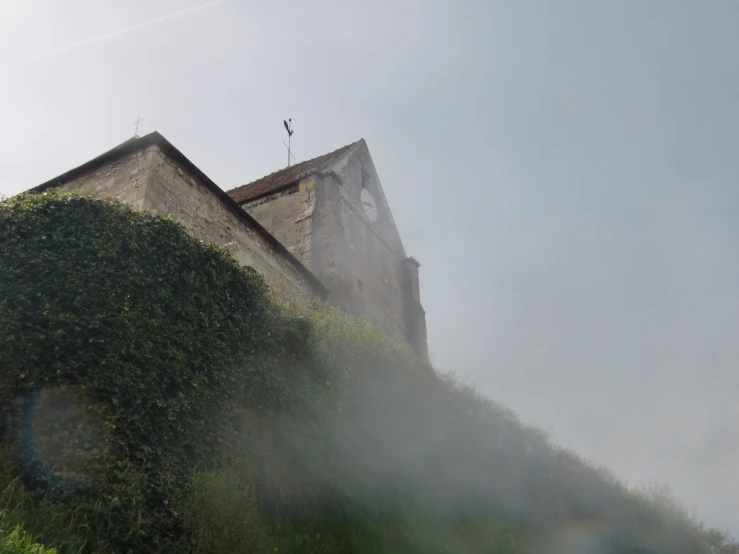 fog rolling by in front of a brick building