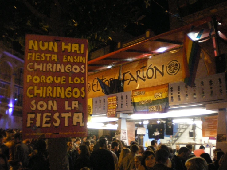 a very crowded street with people holding up signs