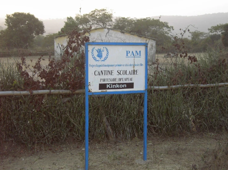 a wooden fence with a sign sitting in front of it