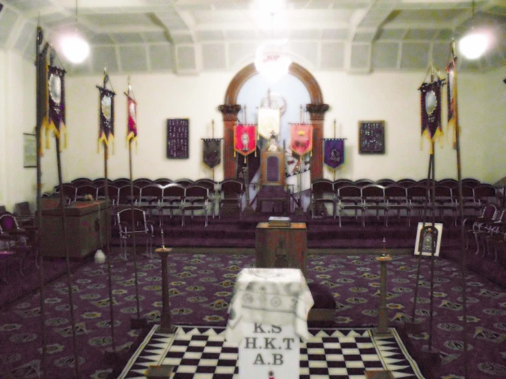 an empty room has flags on the wall and some decorations