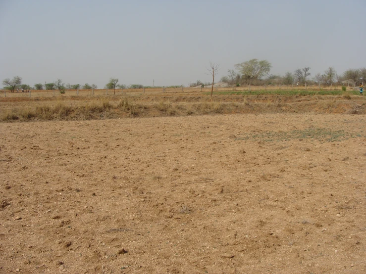 a brown and tan dirt field with no trees