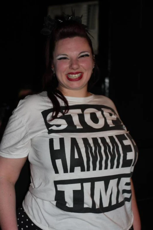 a smiling lady in a t shirt that says stop hammer time