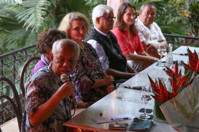 people sitting at a table with drinks in front of them