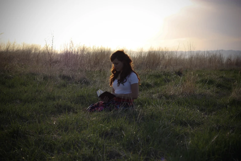 the girl is sitting on the ground alone