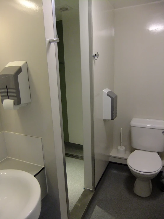 a bathroom with a sink, toilet and shower stall