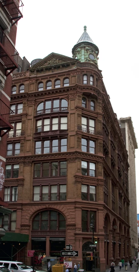 a building on the corner has a steeple