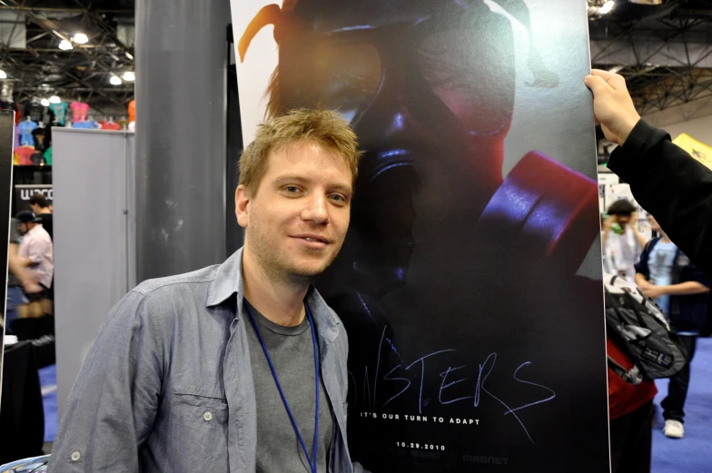 a guy at an exhibit with headphones on