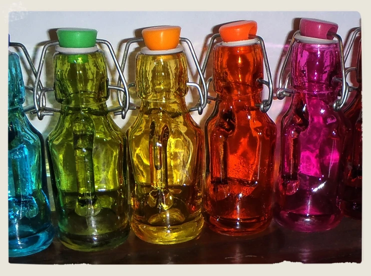 a series of multicolored bottles sit next to each other