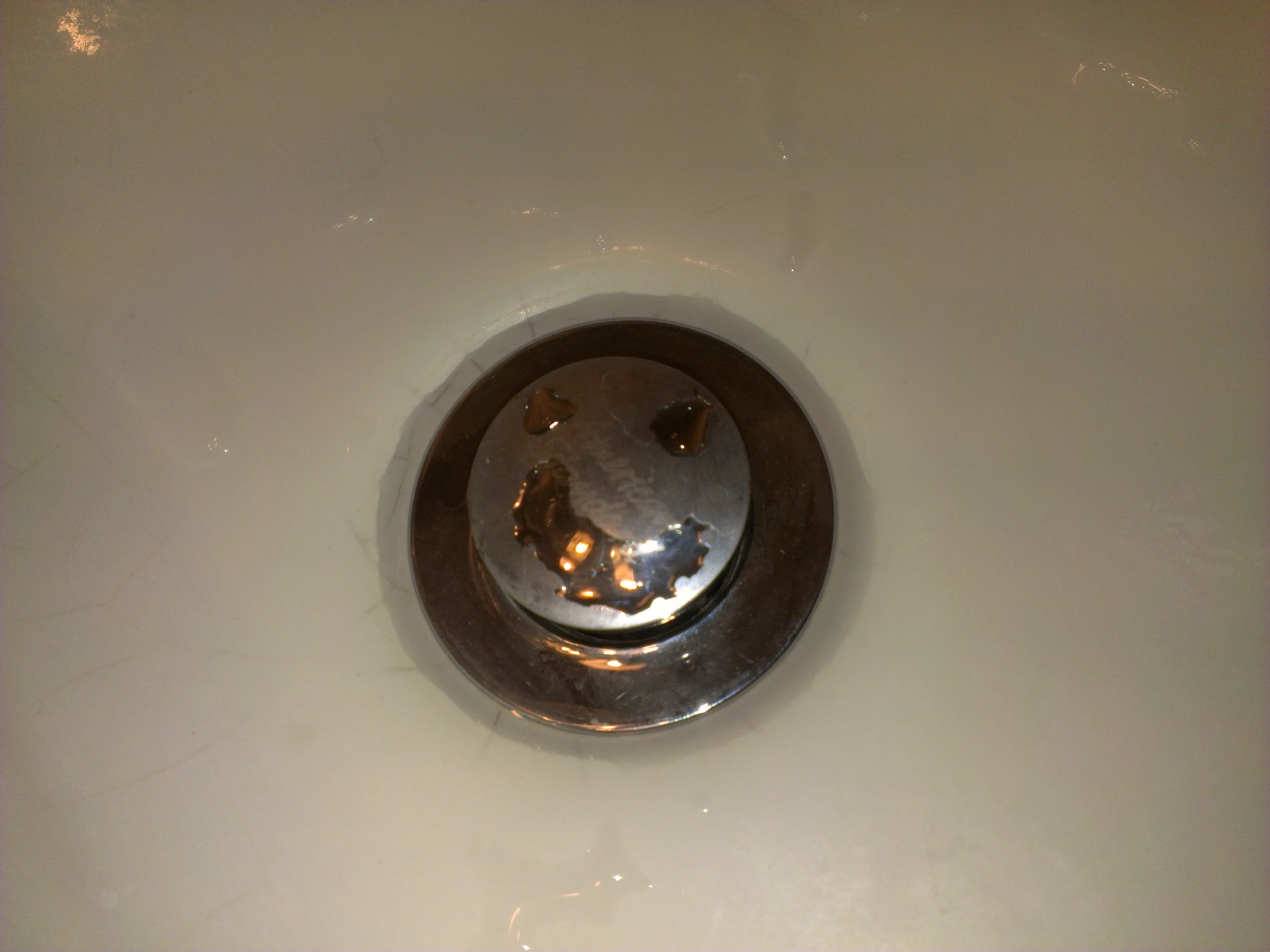 an image of a white sink with shiny chrome