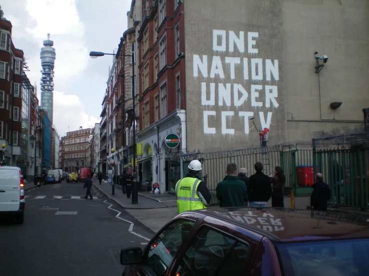 one nation under city sign on a wall in a city