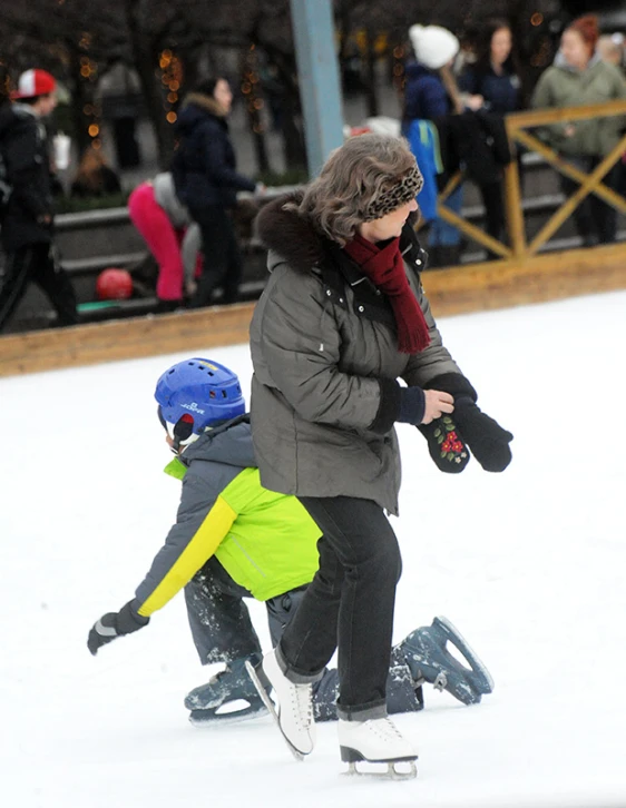 two children are wearing winter gear while skiing