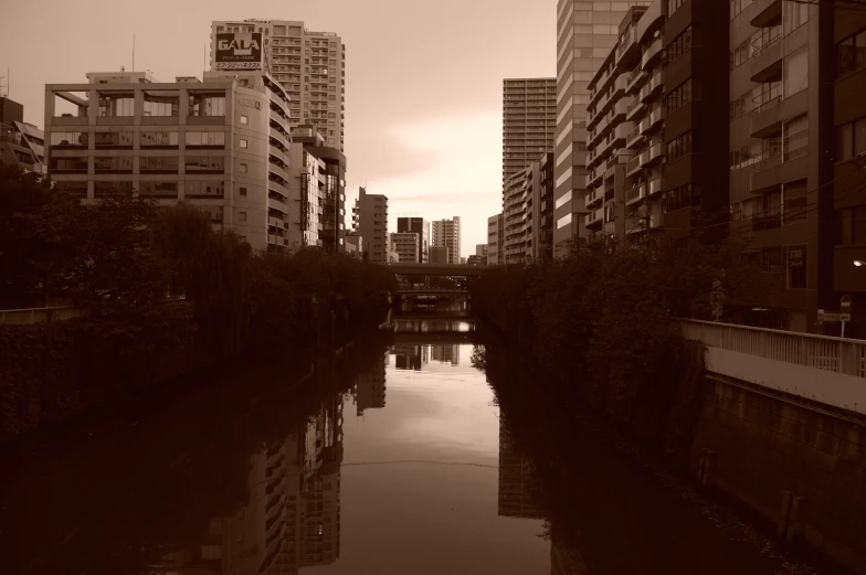 some very tall buildings on a bridge over a river