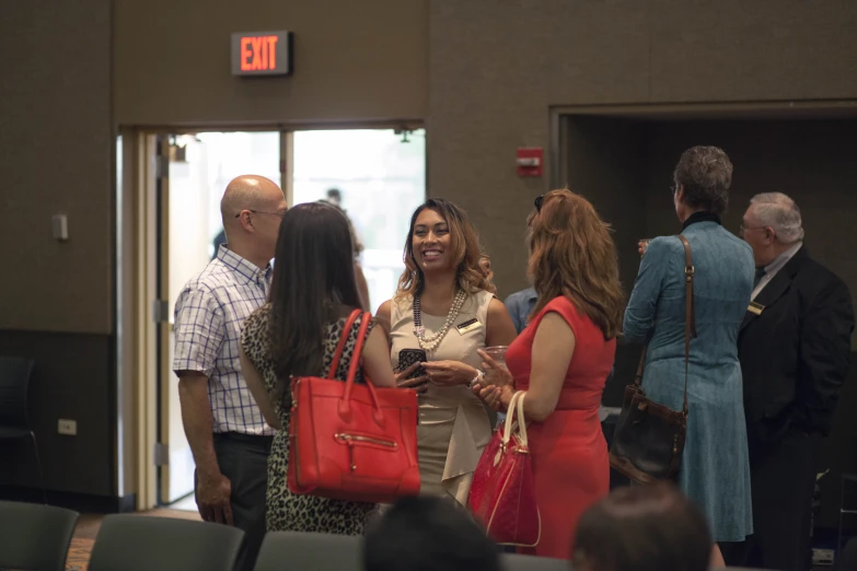 several people talk and laugh as they leave the airport