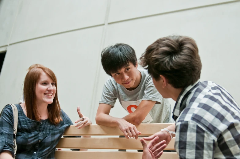 three young men looking at two women smiling