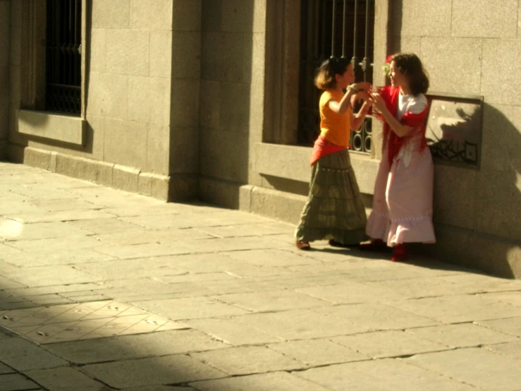 a man that is standing next to a woman in the street