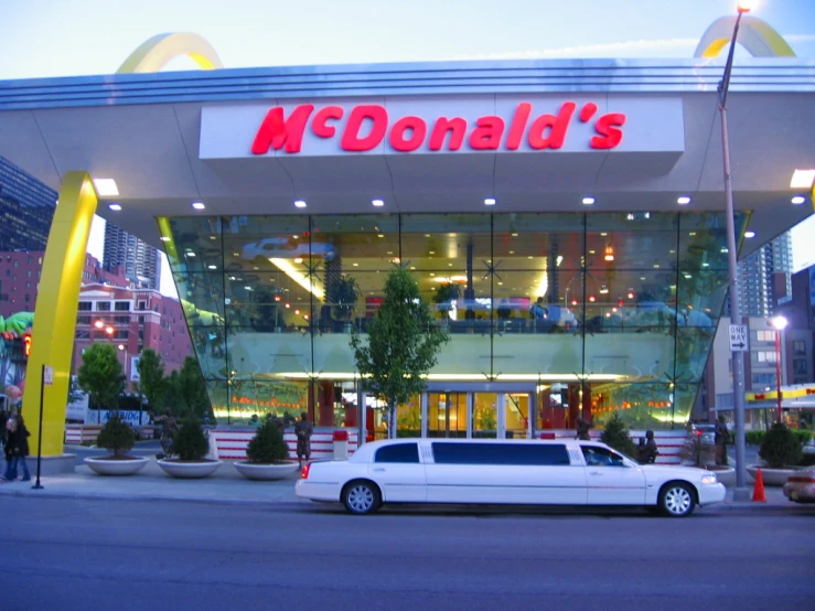 white limo parked in front of mcdonald's restaurant