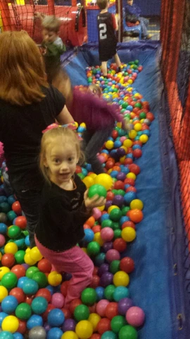 people playing ball pit at an indoor activity center
