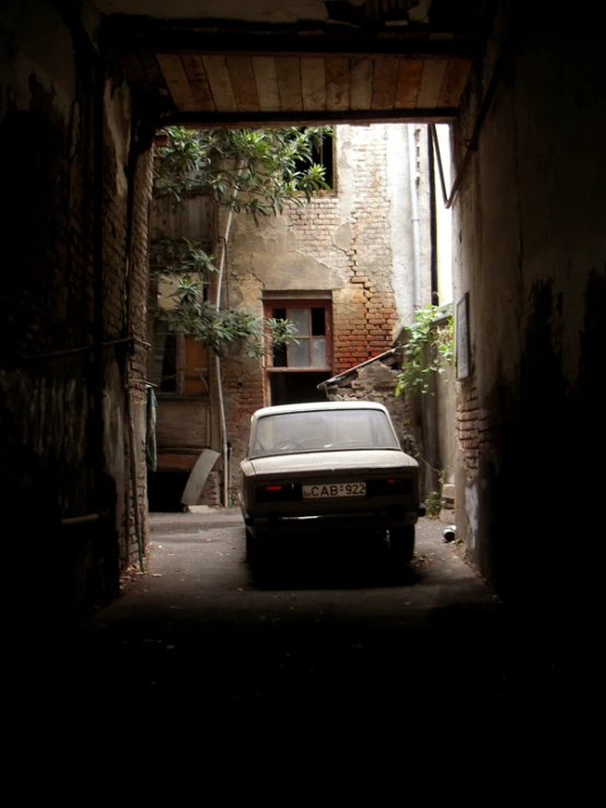 the car is parked outside a small building