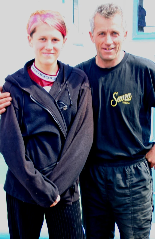 a man and woman posing for the camera