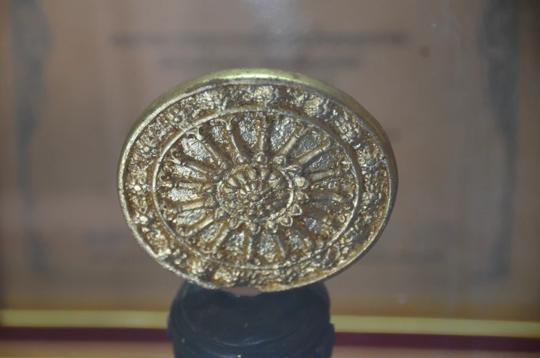 a golden, elaborately decorated round object is pictured