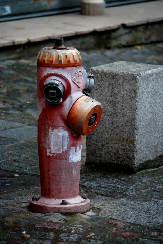 a red and white fire hydrant with graffiti on it